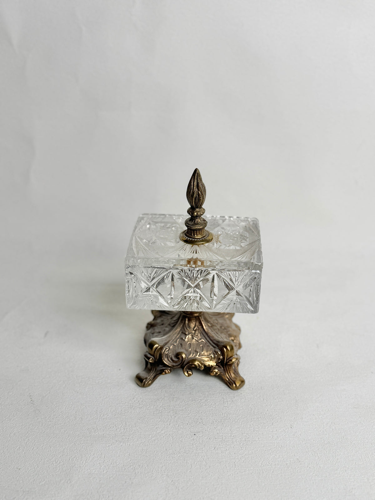 Vintage crystal pedestal jewelry casket, front view on white
