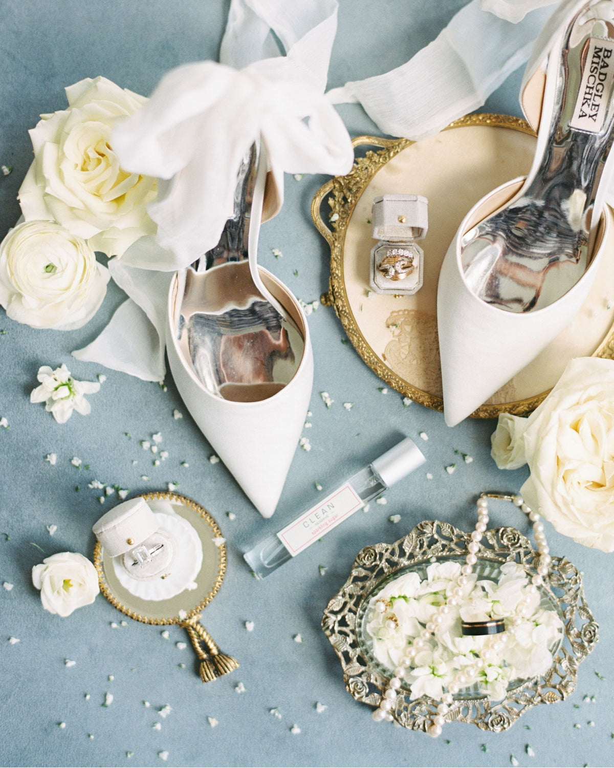Bridal shoes and pearls flat lay on blue with Georgian oval ring boxes