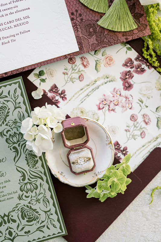 Botanical invitation flat lay with a Mauve Radiant Georgian ring box