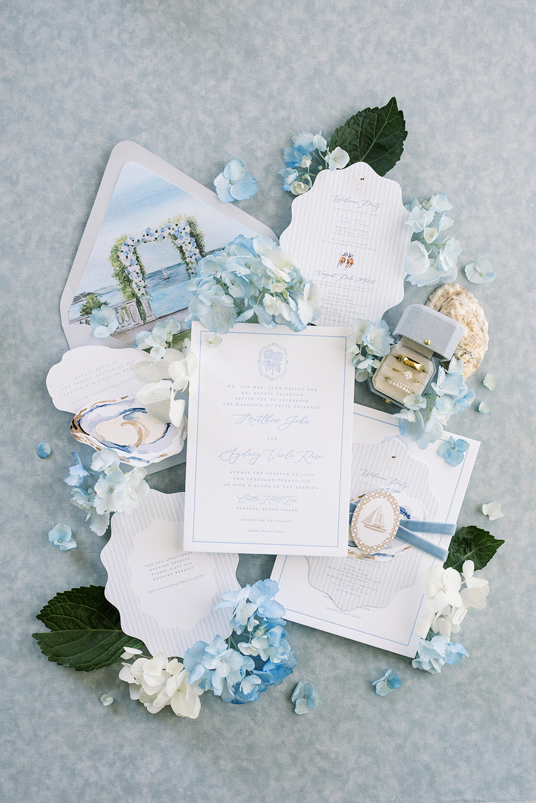 Blue invitation suite with a Hydrangea Radiant Legacy ring box