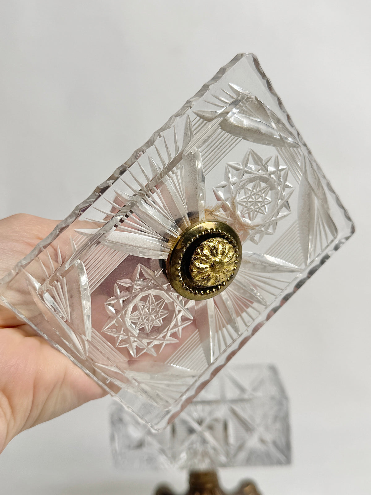 Cut glass lid of the vintage crystal box held in hand
