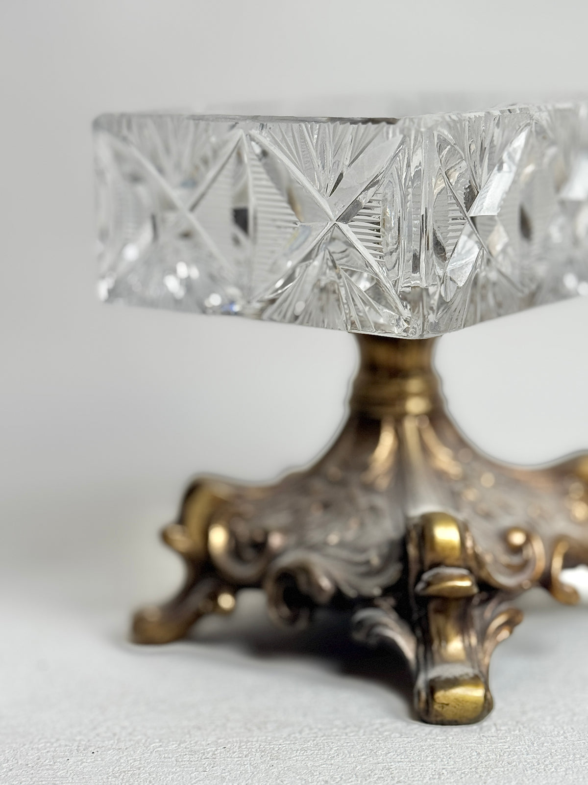 Detail of the crystal box's cut glass and ornate metal pedestal