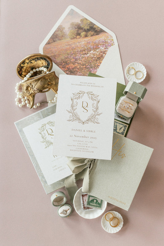 Invitation flat lay with jewelry and a Light Sage Radiant Legacy ring box