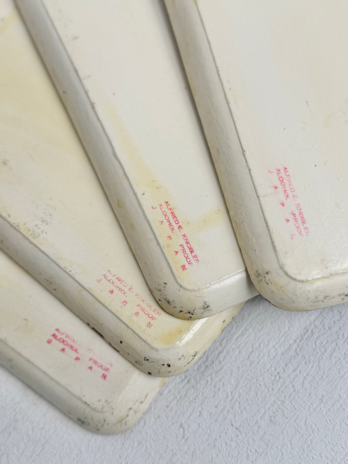 Close-up of the cream rims and backs of the vintage Knobler trays