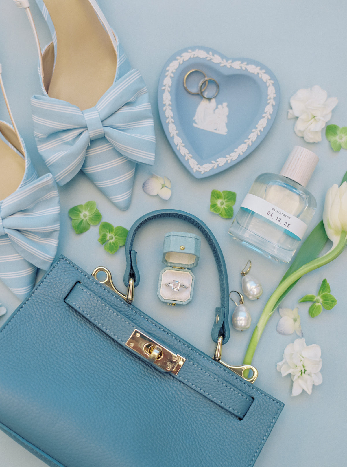 Blue handbag and dish flat lay with a Traverse Bay Radiant Georgian ring box