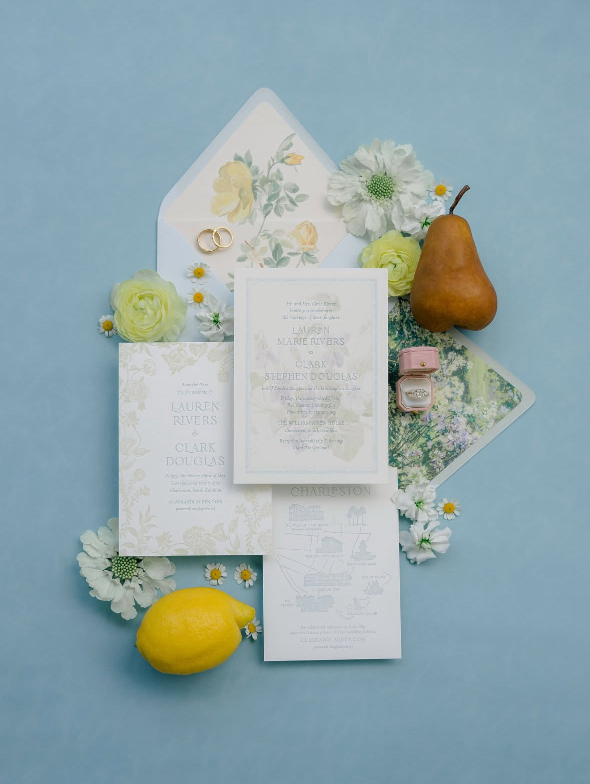 Invitation suite with lemons and pears on a Traverse Bay blue suede styling mat