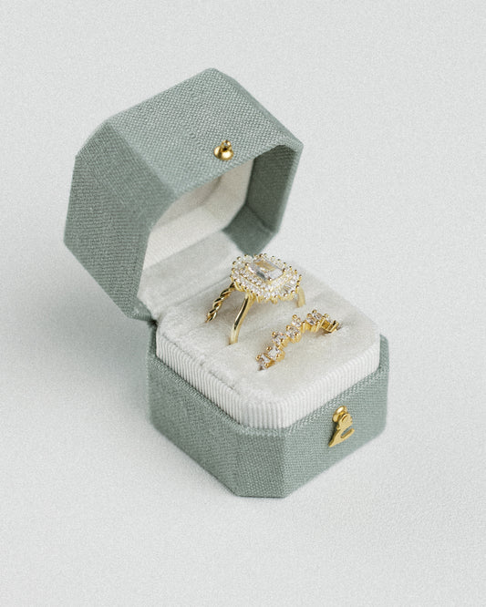 Radiant Legacy beveled square ring box in Light Sage green linen, open with rings