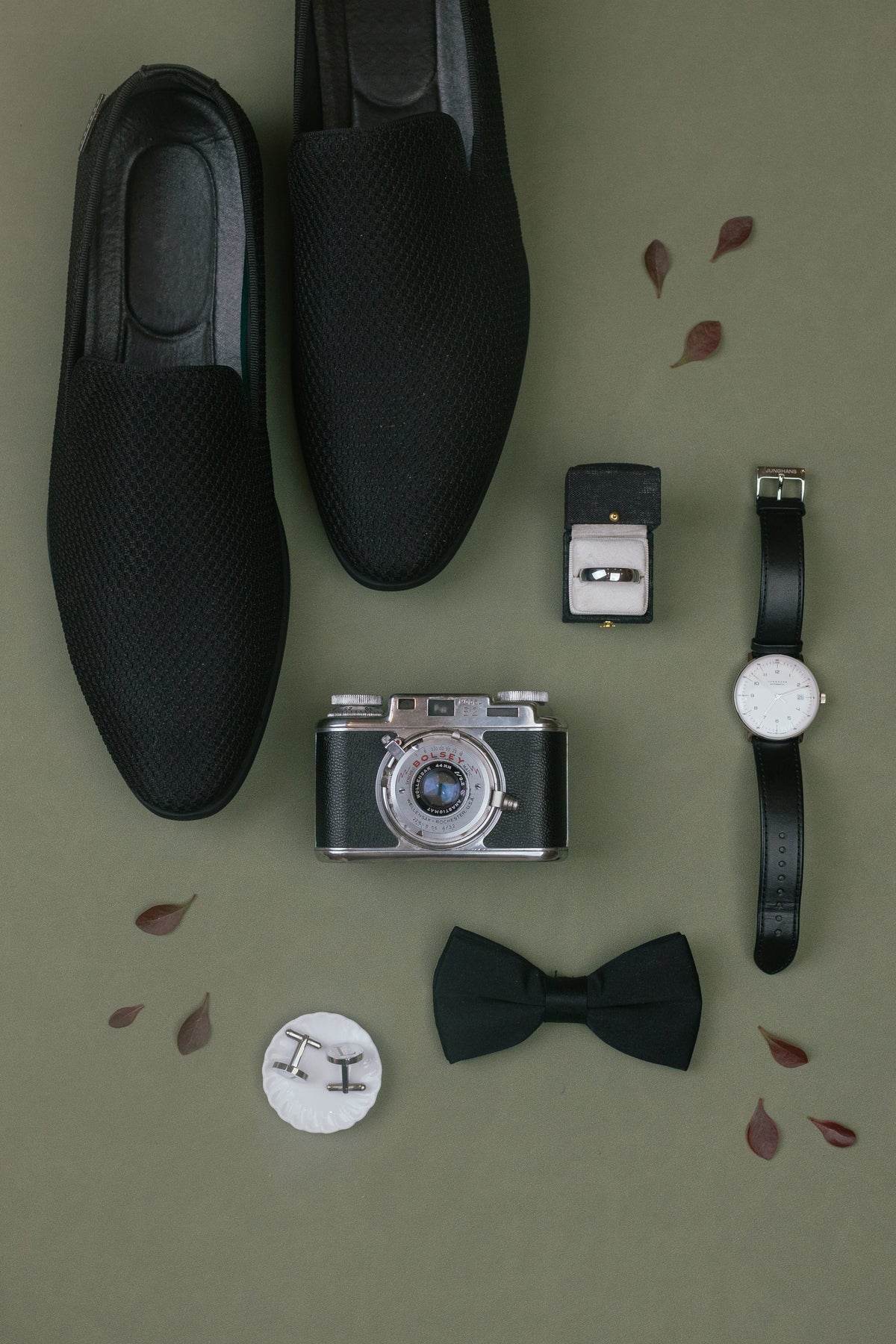 Groom's details with camera and loafers on a Sage suede styling mat